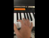 Guy plays  piano with hammer on one key