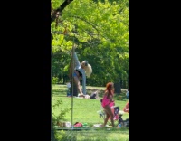 Woman pole dancing Sunday afternoon at park