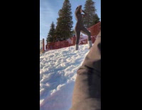 Woman black ski suit poses snowy hill