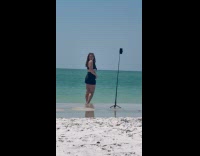 Woman black beach wear beach video shoot