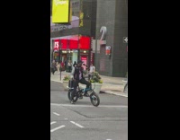 Guy riding bicycle sings karoke 