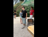 Woman black bikini poses by the waterfalls