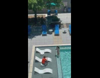 Woman in American flag bikini licks popsicle in the pool