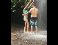 couple selfie stick under water fall