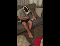 Man wears VR Headset on couch gets scared