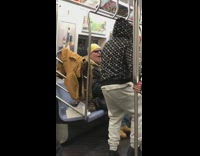 Guy wears VR headset and dances on pole on subway train