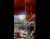 Restaurant staff removing water on awning