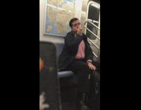 man in red button up brushes teeth on subway