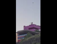 Woman yoga exercise top of mountain pink building