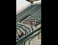 Three women dances at the baseball stadium