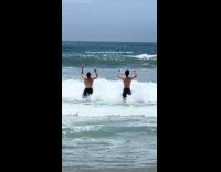 Dad and daughter boyfriend play with waves