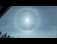 Halo rainbow circle around the sun sky