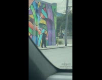 Guy black shirt spin rifle colorful wall