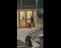 Woman vacuum cleaner along street at night 
