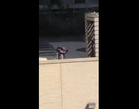 Woman puffer jacket dances on rooftop balcony