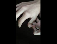 Person bend his thumb backward black background