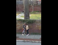 Girl poses for photo on sidewalk