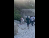 Group of guys sings dances for a couple 