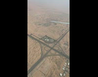 Airplane plane flies over highway freeway dirt