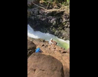 Woman white bikini sunglasses selfie waterfall Hawaii