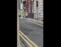 Girl grey sweater sit beside graffiti street