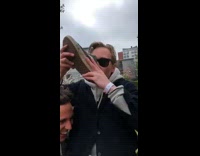 Guy in black sunglasses drinks out of dirty Vans shoe