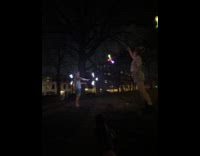 People spin lights sticks and trash can balancer