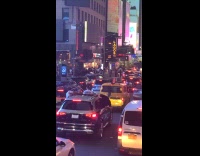 Men on windows of bouncing car traffic
