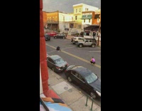 Pink jacket guy poses middle of road 