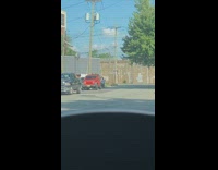 Woman in white shirt tiktok dance on the side of the street