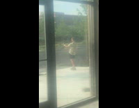 Green shirt guy talks to phone sidewalk 