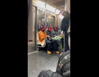 Three people red painted face ride train