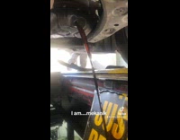 Mechanic smoothly pulls out drain plug 
