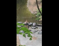 Girl sit pose rocks river stream nature