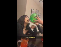 Girl pours empty bottle in friends mouth 