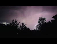 Flashing lights and lightning on night sky