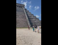 Woman in violet bikini poses in front of the pyramid