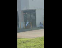 Anime girl poses next to parking lot 