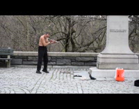 Shirtless guy plays flute with his nose 
