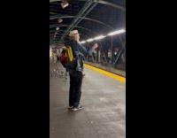 Man stand on subway platform feeds pigeons