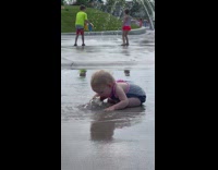 Baby drink the water in a park fountain 