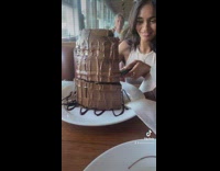 Girl trying to move cake drops it