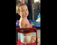 Little boy stares at mom red chair