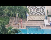 Woman in red bikini top tiktok dance by the pool