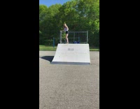 Girl drops down in skate park bowl and falls off skateboard