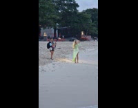 Woman green dress spins for beach video
