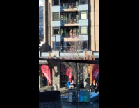 Women in bikini poses snowy building balcony