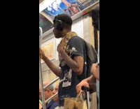 Man on subway with snake around neck