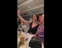 Woman take selfie at banquet party table
