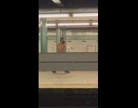 Shirtless sweaty guy face mask practices fighting moves with knife in subway train